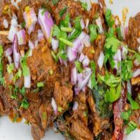 Mutton Sukka · Fresh tender cuts of goat marinated in crushed peppercorns fried with chopped onions and cur...