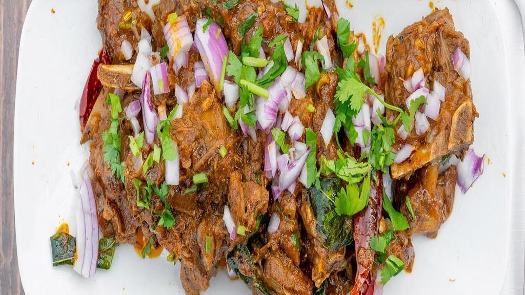 Mutton Sukka · Fresh tender cuts of goat marinated in crushed peppercorns fried with chopped onions and curry leaves.
