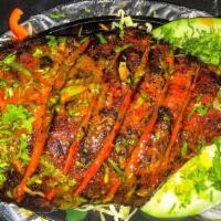 Tandoori Pompret Fish · Pompret fish marinated in a blend of spices and baked to perfection in clay oven