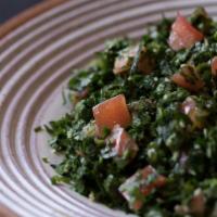 Tabouleh Salad · Vegetarian. Finely chopped parsley, with tomatoes, mint, onion, bulgur, and seasoned with ol...