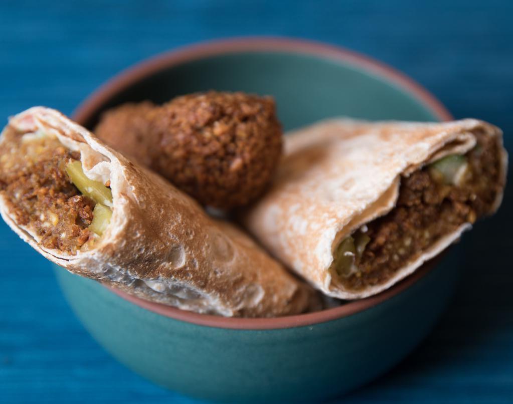 Falafel Wrap · Vegetarian. Ground chickpeas with parsley, served with hummus, Jerusalem salad, tomatoes, and a pickle.