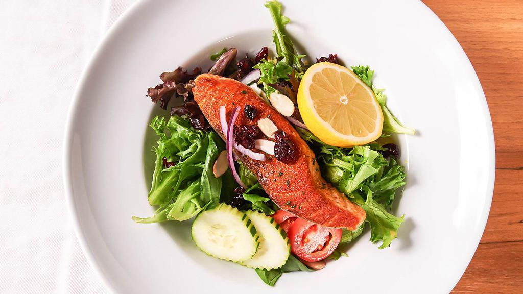 Grilled Salmon Salad · Served with signature ginger dressing, topped with cranberries, tomato, onion, and almond.