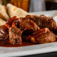 Us 12 Famous Cajun Steak Bites · Grilled steak, mushrooms, tossed in our house hot sauce and Cajun spice with pita and a side...
