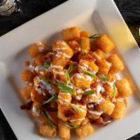 Chubby Checker’S Twisted Tots · Queso cheese with bacon garnished with cheddar cheese, Scallions and sour cream.