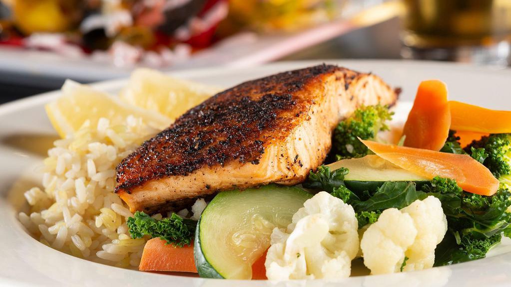 Salem Witchcraft Salmon · Seared on top of Cool Cucumber Dill Sauce served with veg of the Day and Rice.
