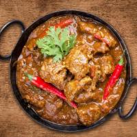 United Lamb Curry  · Pieces of Lamb cooked in a classic brown curry with Indian whole spices.