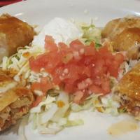 Pleasant Hill Special · Four little chimichangas, tow chicken and two beef, topped with cheese sauce and enchilada, ...