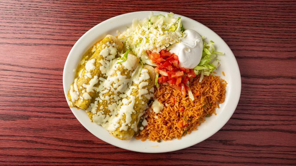 Enchiladas Verdes · Tree chicken enchiladas topped with salsa Verde, sour cream, guacamole. Served with rice, lettuce and tomatoes.