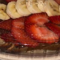 Nutella Toast · Brioché bread topped with Nutella, fresh strawberries,banana and chocolate drizzle.