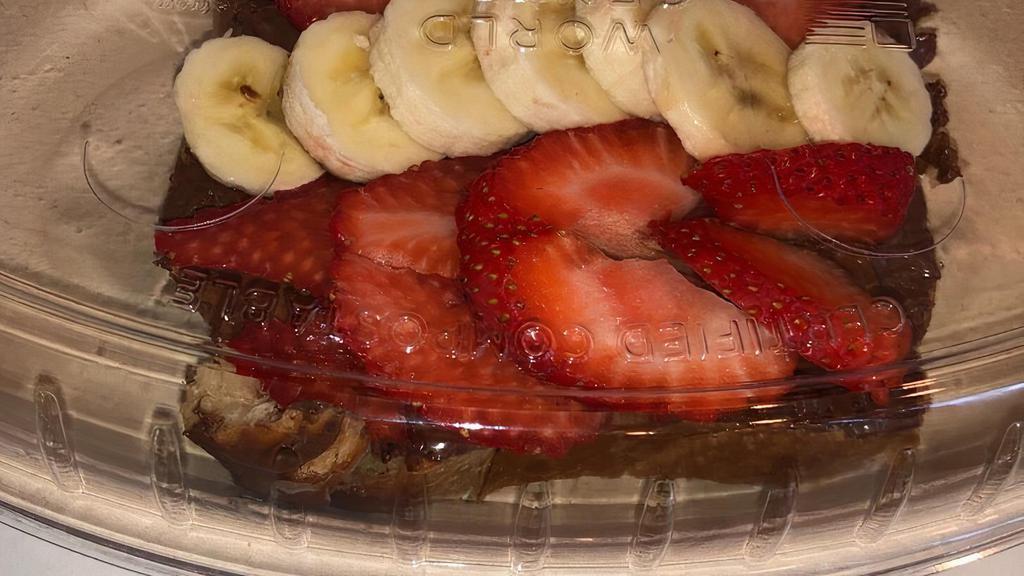 Nutella Toast · Brioché bread topped with Nutella, fresh strawberries,banana and chocolate drizzle.