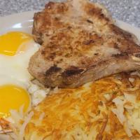 Pork Chops And Eggs · 2 Pork Chops with 2 eggs any style and with  hash browns and toast.