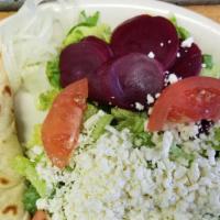  Large  Greek Salad · Lettuce, tomatoes, olives, pepperoncini, beets. Onions, and feta cheese. Served with pita br...