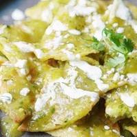 Chilaquiles Verdes No Meat · Crispy corn tortillas, smothered in a verde sauce and two Over easy egg. Cilantro, queso fre...