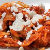 Chilaquiles Rojos No Meat · Crispy corn tortillas, smothered in a red sauce and two Over easy egg. Cilantro, queso fresc...