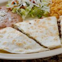Quesadilla With Meat · Grilled tortilla with melted cheese inside and meat, served with rice and beans.