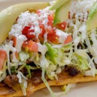 Huarache · Tasty oval-shaped corn masa tortilla. Top them with beans, meat, lettuce, tomatoes,mexican c...
