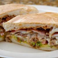 Speciality Torta · Mexican sandwich served on a soft roll and filled with Beans, avocado, tomatoes, onions, and...