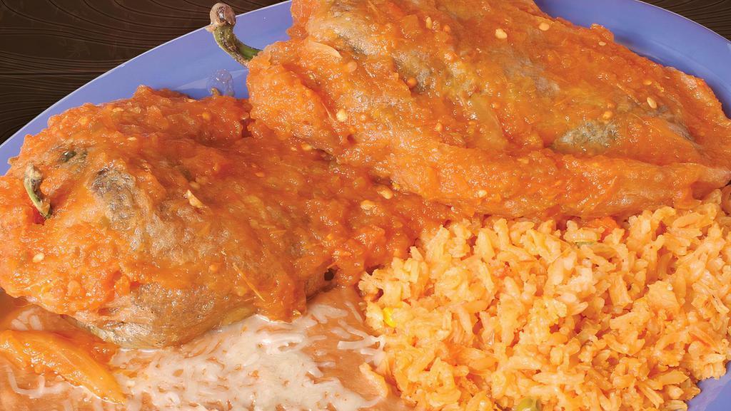 Chiles Rellenos · Poblano pepper stuffed with cheese, served with tomato sauce.