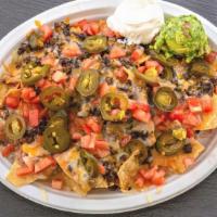 Nachos · fried tortilla chips topped with refried beans, choice of meat, shredded cheese mix melted a...