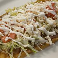 Huarache · With beans, sauce, lettuce, tomato, cheese and sour cream.