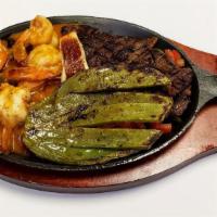 Combinacion Mar Y Tierra · Grilled skirt steak with shrimp and grilled cactus served with rice, beans, salad and tortil...