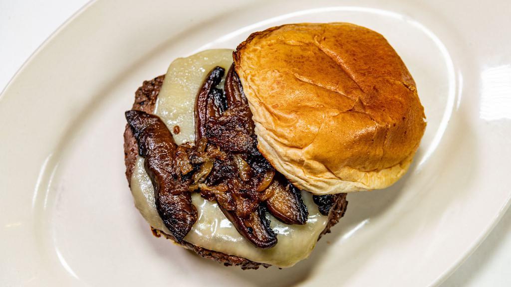 Mushroom Swiss Burger · 1/3 lb  Black Angus Beef patty, grilled onion, portabella mushroom and Swiss on a grilled brioche bun. Add bacon for an additional charge.