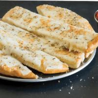 Cheesy Breadstix · Our standard breadstix just got cheesy! Each one is topped with plenty of mozzarella cheese ...