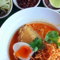 Kanome Chine · Spicy. Ground chicken in a red curry broth with vermicelli noodles topped with carrots, red ...
