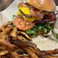 The Dude Deluxe · Two 3-ounce patties smashed and flash grilled, and topped with apple-wood bacon, American ch...