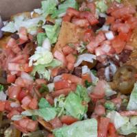 Ultimate Nachos · A huge serving of Ann Arbor Tortilla Chips with your choice of meat, Monterey jack and chedd...