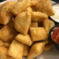 Dough Nuggets · bite-sized pieces of fried pizza dough tossed in a parmesan garlic butter sauce and served w...