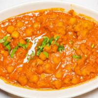 Chana Masala · Aromatic chickpeas cooked with tomatoes, onions, ginger, and in a exotic of indian spices.