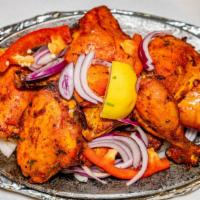 Tandoori Chicken · House special marinated in spicy tandoori sauce with herbs, ginger, garlic & homemade yoghur...