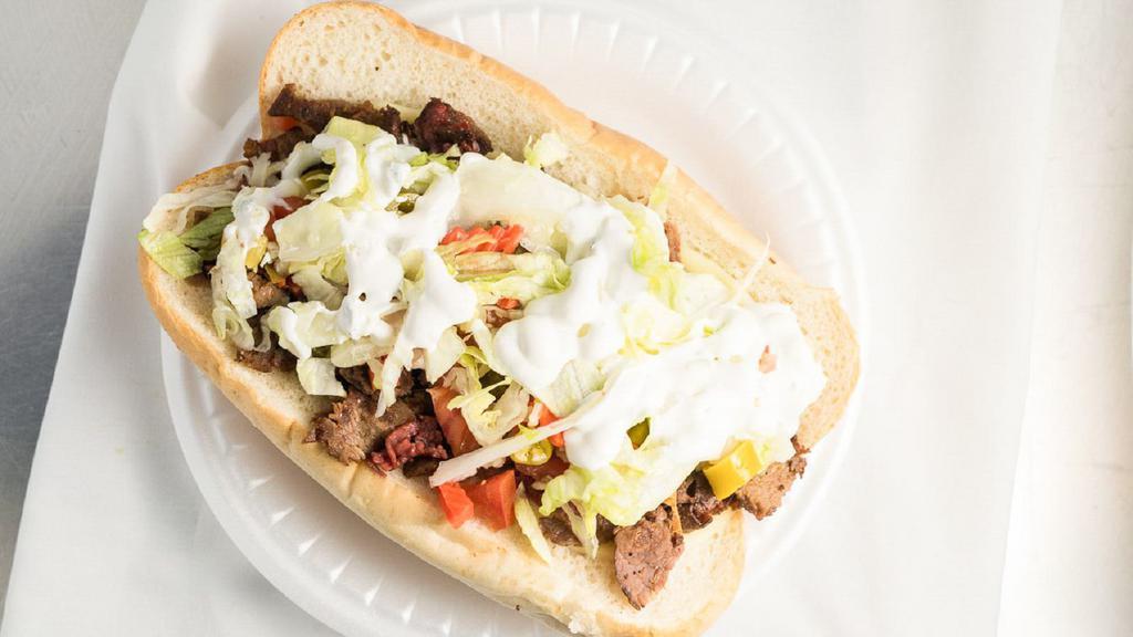 Gym Shoe · Italian beef, gyro meat, and corn beef with provolone cheese, lettuce, tomatoes, giardiniera peppers, and gyro sauce.