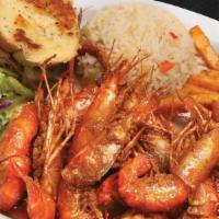 Langostinos · Prawns sautéed in spicy house seasoning. Served with fries, salad, and rice.