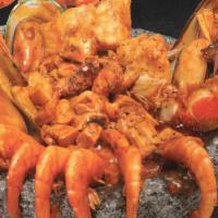 Molcajete De Mariscos · Crab legs, mussels, langostinos, scallops, shrimp, octopus, and surimi sautéed in a spicy sa...