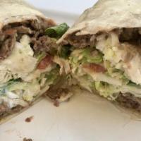 Burrito · Your choice of meat, beans, lettuce, tomato, cheese, and sour cream wrapped in a flour torti...