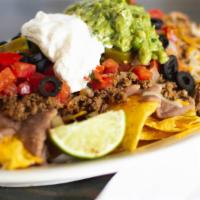 Nachos With Meat · Corn chips covered with your choice of meat, cheese, sauce, beans, lettuce, jalapenos, guaca...