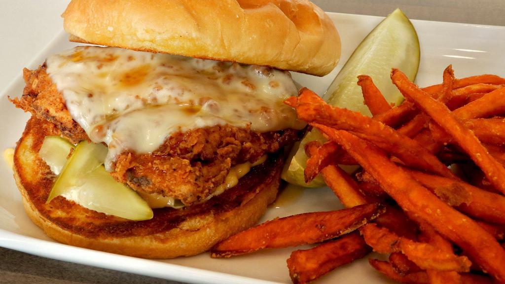 Nashville Chicken Sandwich · Tender chicken breast marinated in buttermilk, dusted in seasoned flour, fried crispy on a brioche roll with monterey jack Nashville hot mayo, Mike's Hot Honey, and sliced pickles.
