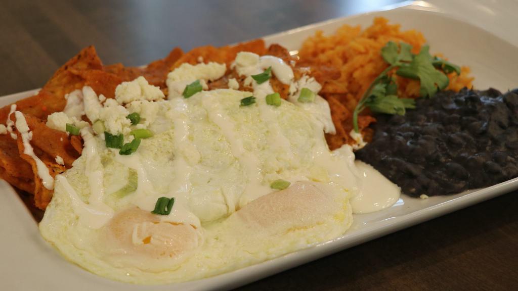 Chilaquiles · Corn tortillas, house-made red salsa, three eggs any style, queso fresco Mexican cheese, sour cream, served with black beans and Mexican rice. add grilled steak for an additional charge.