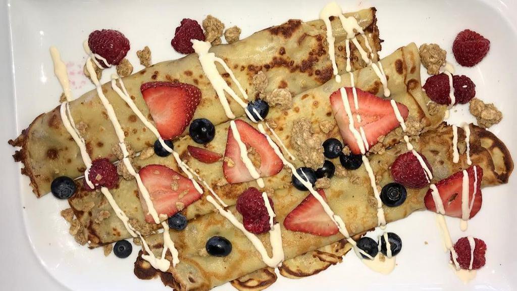 Granola Berry Crepes · French-style crepes filled with sweetened cream cheese, fresh strawberries, and blueberries, Colectivo small batch granola and topped with toasted almonds.