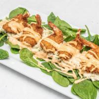 Boom Boom Shrimp  · Panko covered shrimp resting on a bed of spinach and coleslaw. Drizzled Boom Boom sauce on t...