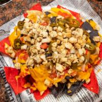 Nacho Nacho Man · Tri-colored chips layered with melted nacho cheddar cheese sauce, tomatoes, white onion, and...