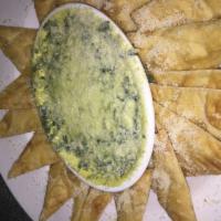 Spinach Dip · A creamy blend of artichoke hearts, spinach and Parmesan cheese, served with pita bread wedg...