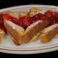 French Toast · Dusted w/powder sugar & served W/ syrup& butter.