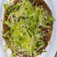 Huaraches · Oval shaped tortilla filled with refried beans and topped with green hot salsa, lettuce, cot...