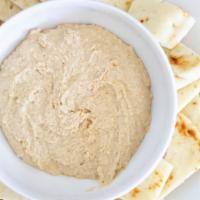 Hummus Dip · A delicious dip made with olive oil, lemon, garlic, and special seasoning served with pita c...