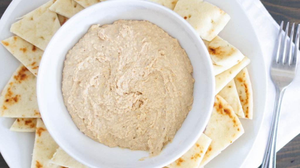 Hummus Dip · A delicious dip made with olive oil, lemon, garlic, and special seasoning served with pita chips.