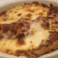 Ravioli Al Forno · Homemade ravioli filled with seasoned beef, and Italian sausage, fried then coated with our ...