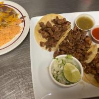 Tacos De Carne Asada · Three steak tacos served in corn or flour tortillas with onion and cilantro.